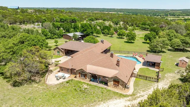 an aerial view of a house with a yard