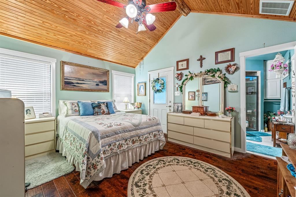 475 Magic Valley Bluff Dale, TX 76433 - Photo 36 of 40 a spacious bedroom with a bed and a chandelier