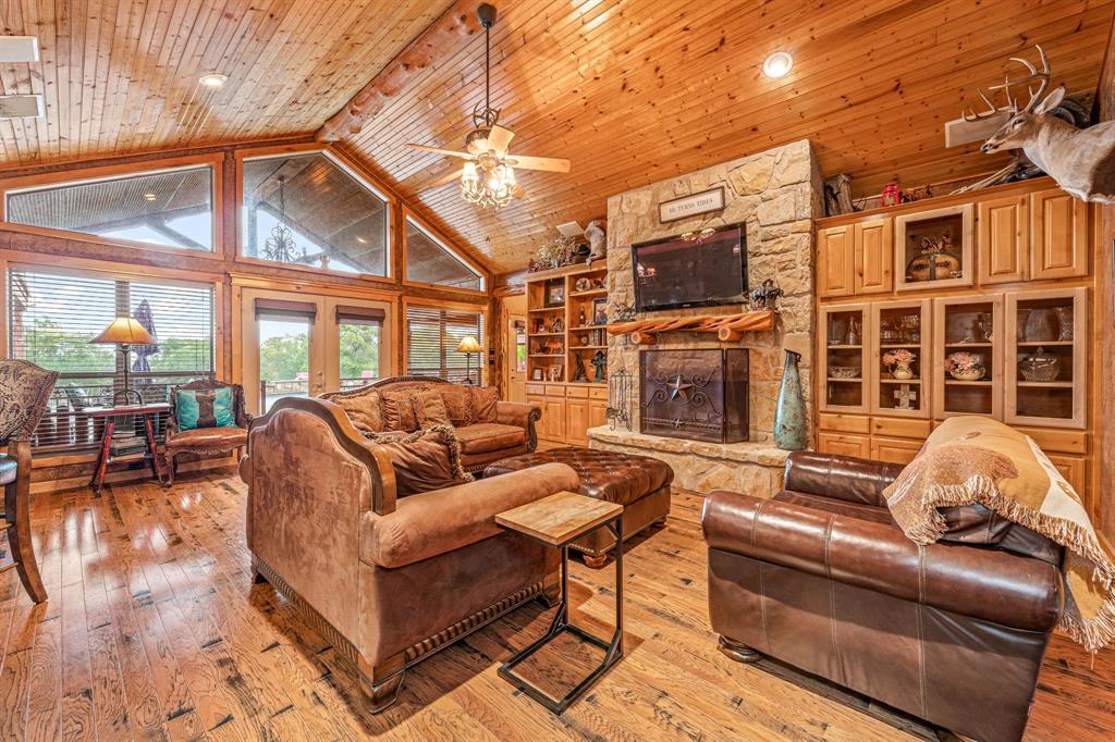 475 Magic Valley Bluff Dale, TX 76433 - Photo 5 of 40 a living room with furniture a flat screen tv and a floor to ceiling window