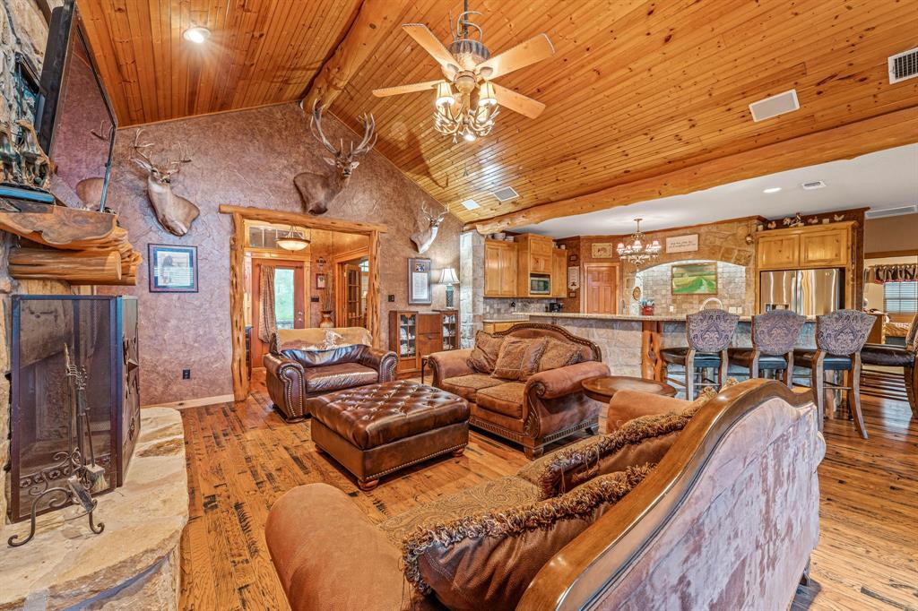 475 Magic Valley Bluff Dale, TX 76433 - Photo 9 of 40 a living room with furniture a chandelier and a dining table with wooden floor