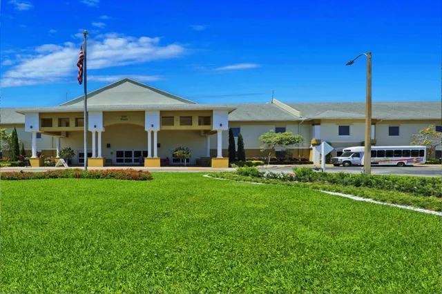 a front view of a house with a garden and patio