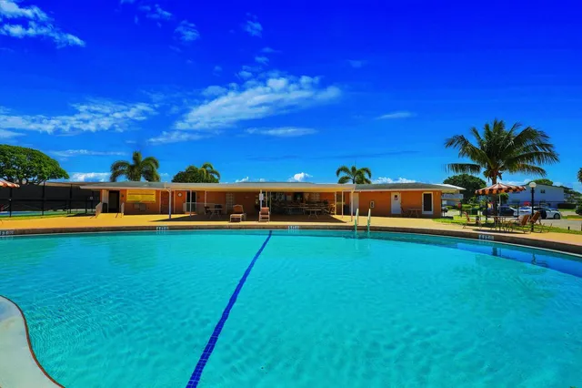 a view of swimming pool with a big yard