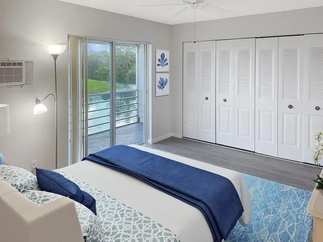 a bedroom with a large bed and a window