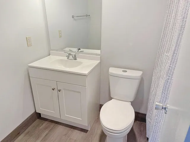 a bathroom with a toilet sink and a mirror