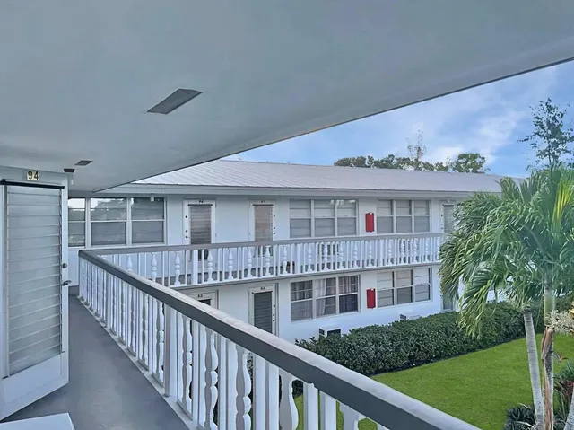 a view of a house with brick walls and deck