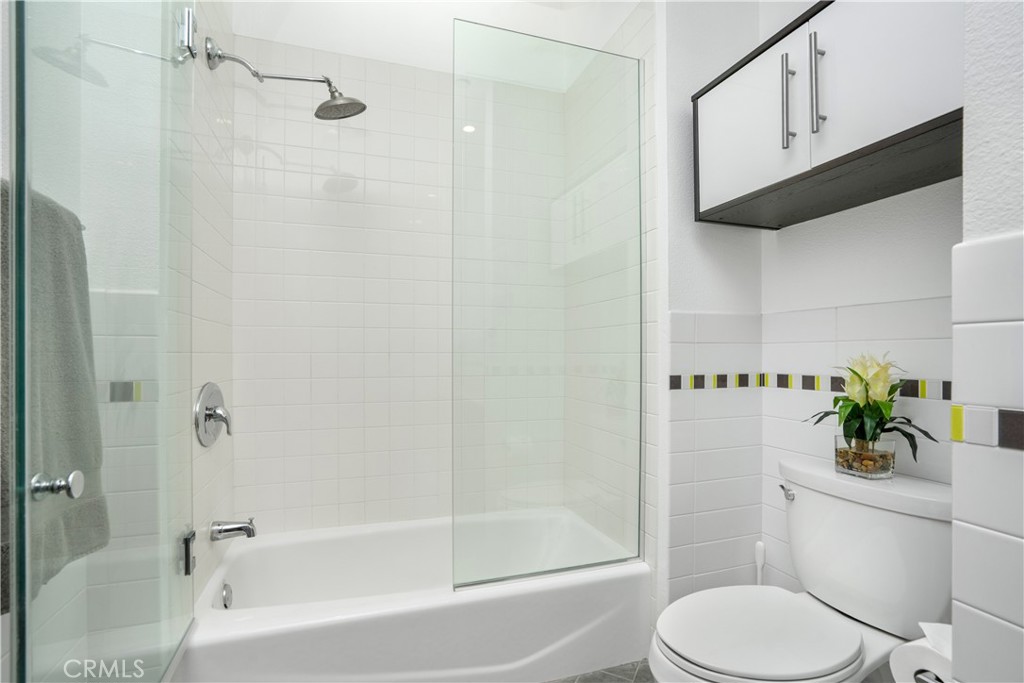 133 The Promenade North, Unit 422 Long Beach, CA 90802 - Photo 11 of 52 a white toilet sitting next to a bath tub