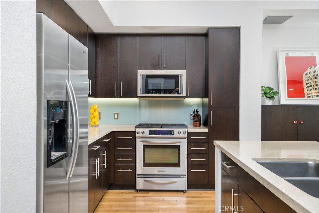 133 The Promenade North, Unit 422 Long Beach, CA 90802 - Photo 16 of 52 a kitchen with a stove and a microwave