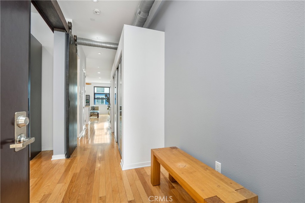 133 The Promenade North, Unit 422 Long Beach, CA 90802 - Photo 4 of 52 a bedroom with a bed and wooden floor