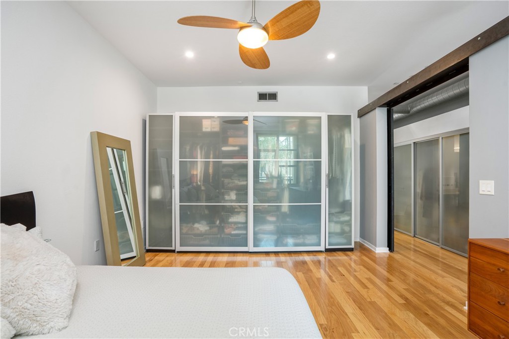 133 The Promenade North, Unit 422 Long Beach, CA 90802 - Photo 7 of 52 a view of a room with wooden floor and a ceiling fan