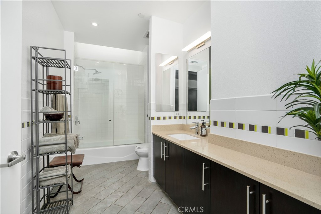 133 The Promenade North, Unit 422 Long Beach, CA 90802 - Photo 10 of 52 a spacious bathroom with a double vanity sink a mirror and shower