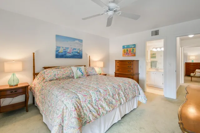a bedroom with bed and a chandelier