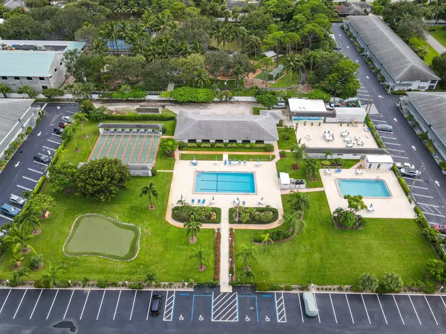 an aerial view of residential house with outdoor space and parking