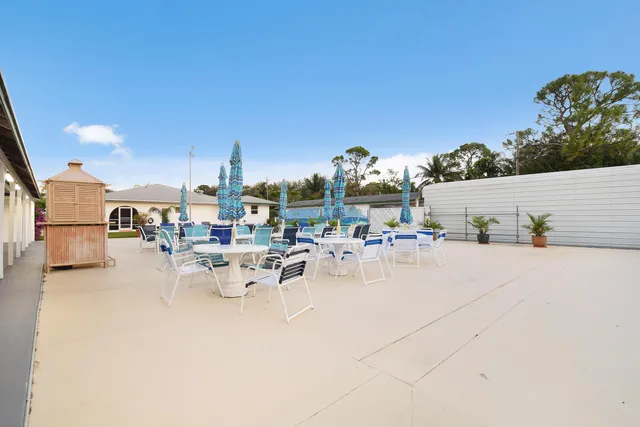 a view of a patio with dining table and chairs