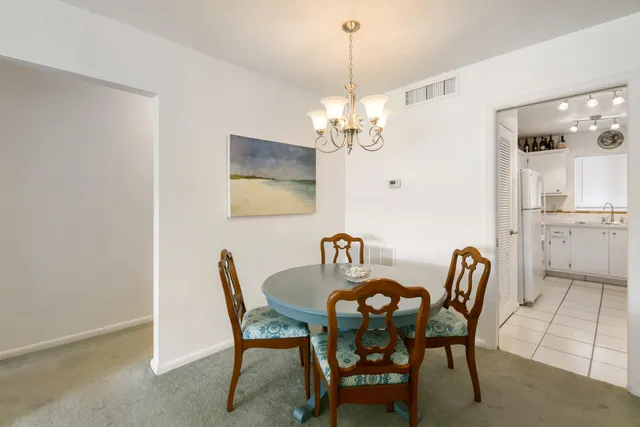 a view of a dining room with furniture and chandelier