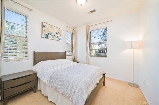 a bedroom with a large bed and a window