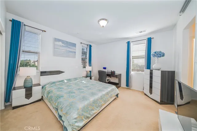 a bedroom with a bed and large window