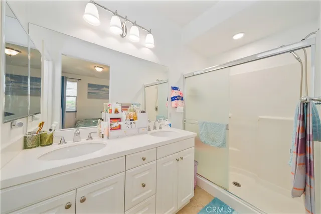 a bathroom with a sink double vanity and a mirror
