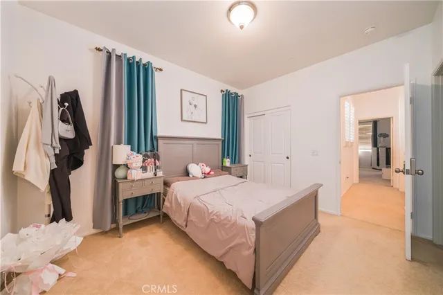 a bedroom with a bed and a flat tv screen