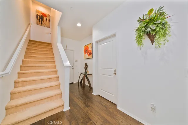 a view of entryway with stairs and wooden floor