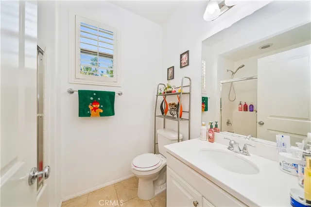 a bathroom with a sink toilet and a mirror