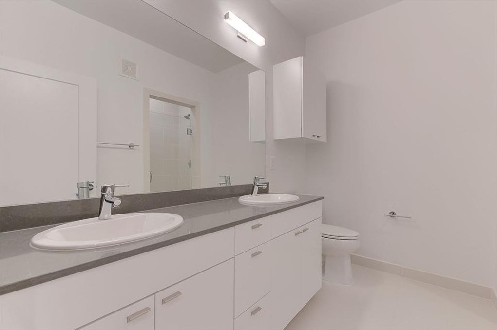 4361 South Congress Avenue, Unit 210 Austin, TX 78745 - Photo 12 of 30 a bathroom with a granite countertop sink and a mirror
