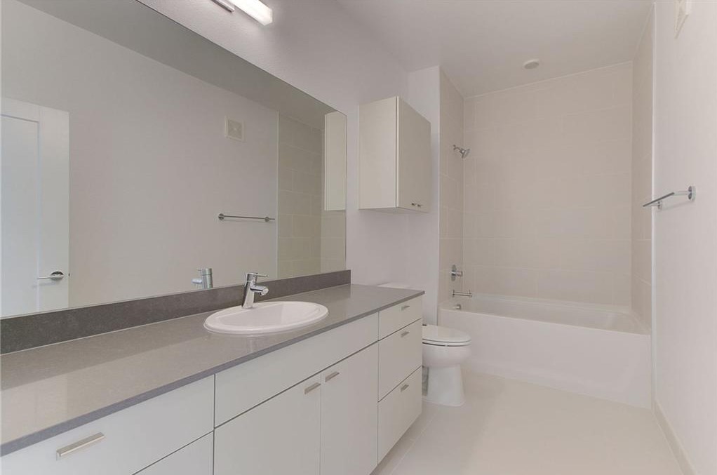 4361 South Congress Avenue, Unit 210 Austin, TX 78745 - Photo 15 of 30 a bathroom with a sink a toilet and shower