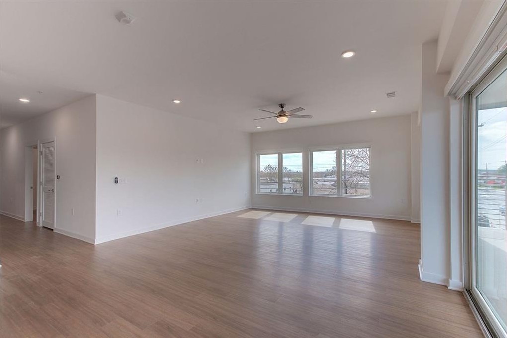 4361 South Congress Avenue, Unit 210 Austin, TX 78745 - Photo 16 of 30 a view of an empty room with wooden floor and a window