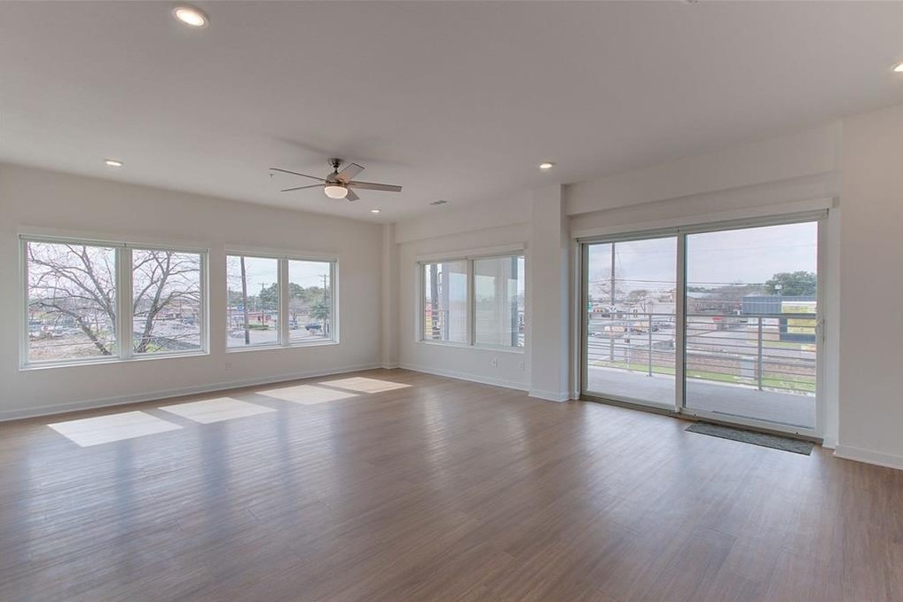 4361 South Congress Avenue, Unit 210 Austin, TX 78745 - Photo 17 of 30 an empty room with wooden floor and balcony