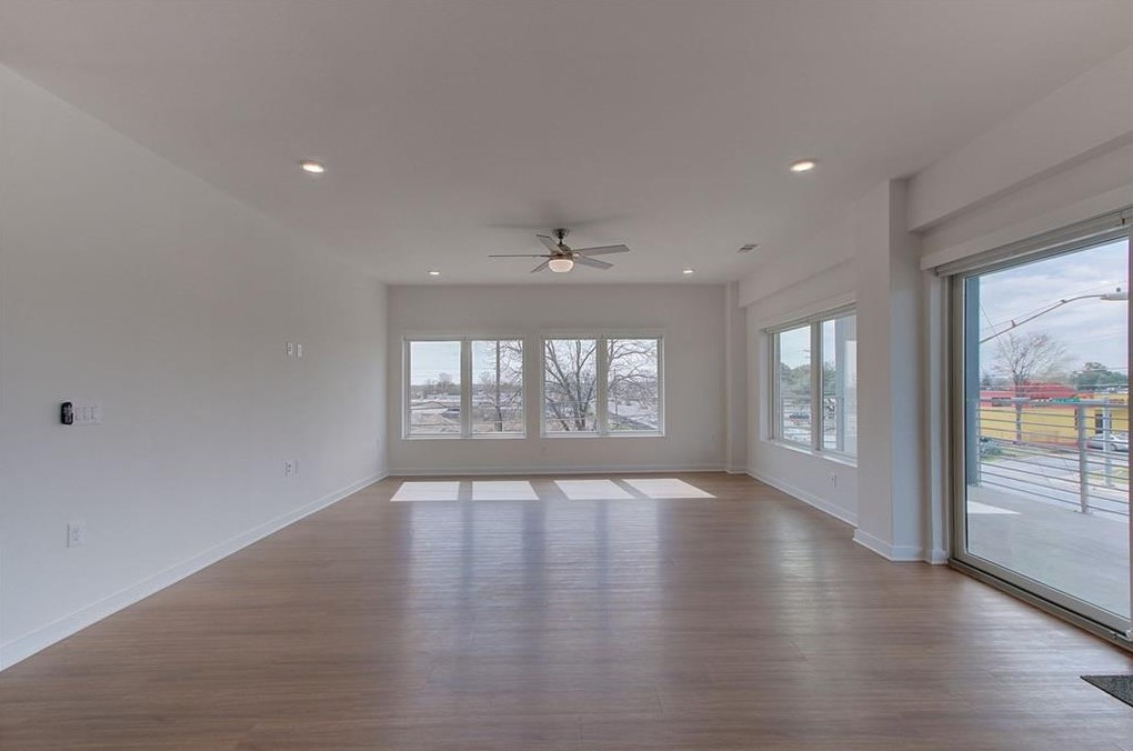 4361 South Congress Avenue, Unit 210 Austin, TX 78745 - Photo 19 of 30 a view of an empty room with wooden floor and a window