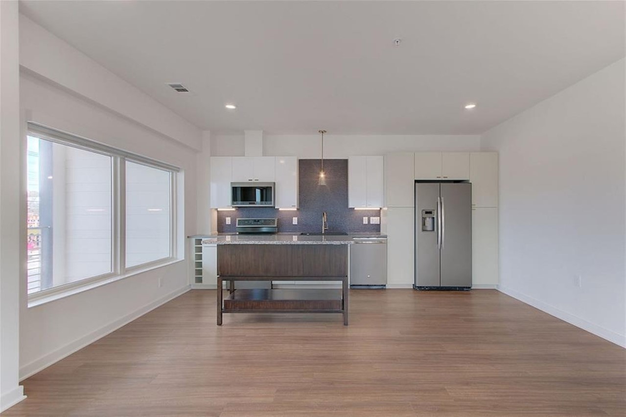 a view of kitchen with furniture and wooden floor