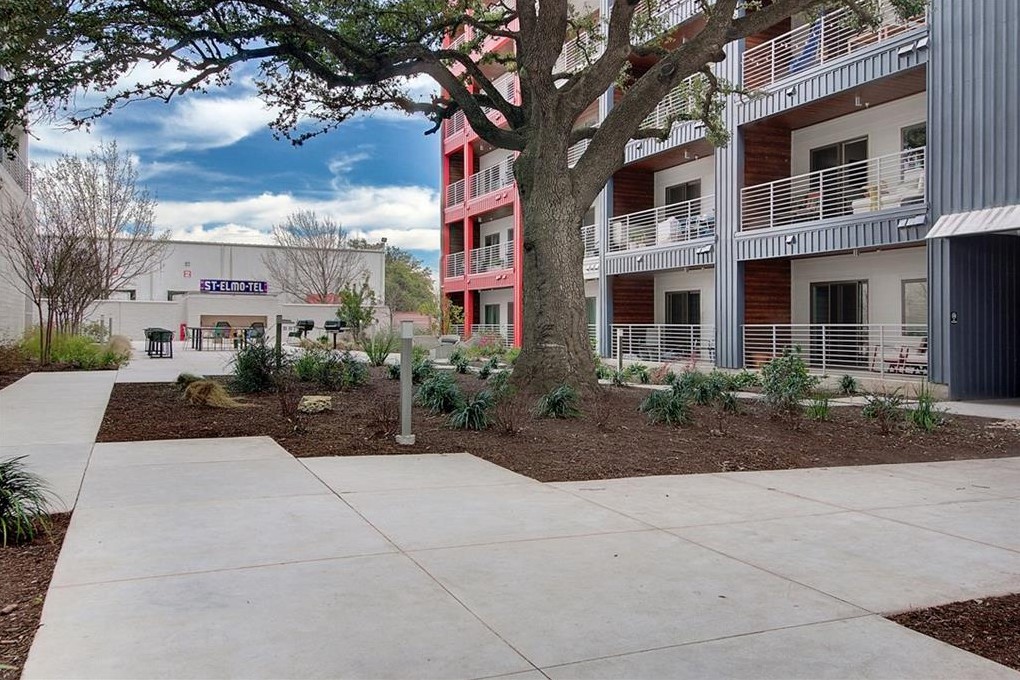 4361 South Congress Avenue, Unit 210 Austin, TX 78745 - Photo 23 of 30 a view of a building with a yard