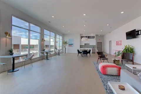 a view of a chairs and table in the back yard of the building