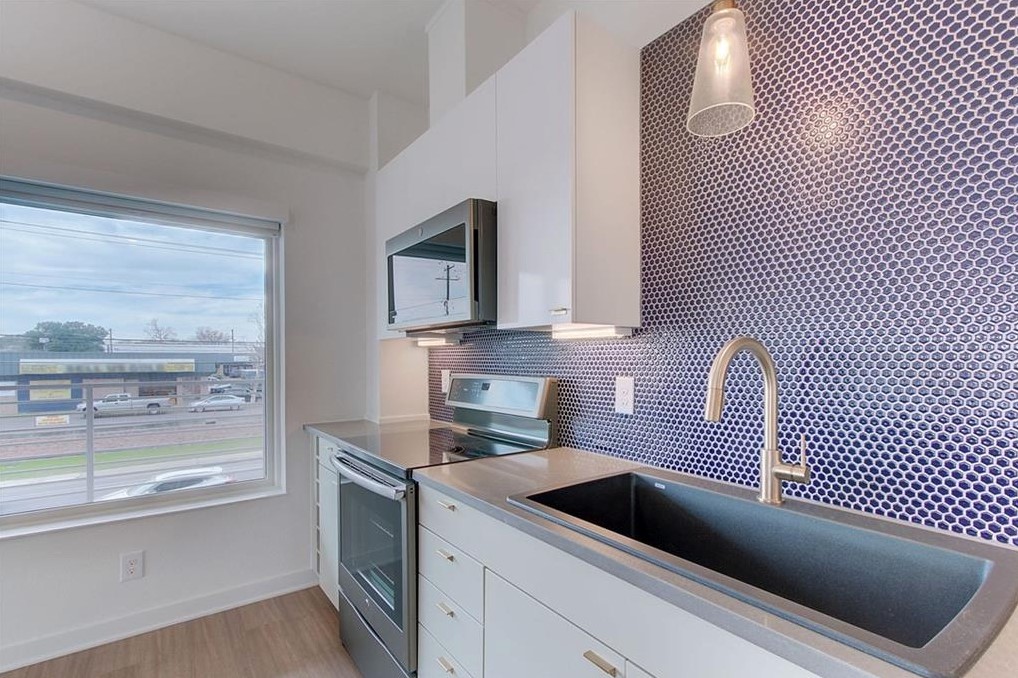 4361 South Congress Avenue, Unit 210 Austin, TX 78745 - Photo 2 of 30 a kitchen with a cabinets and a stove top oven