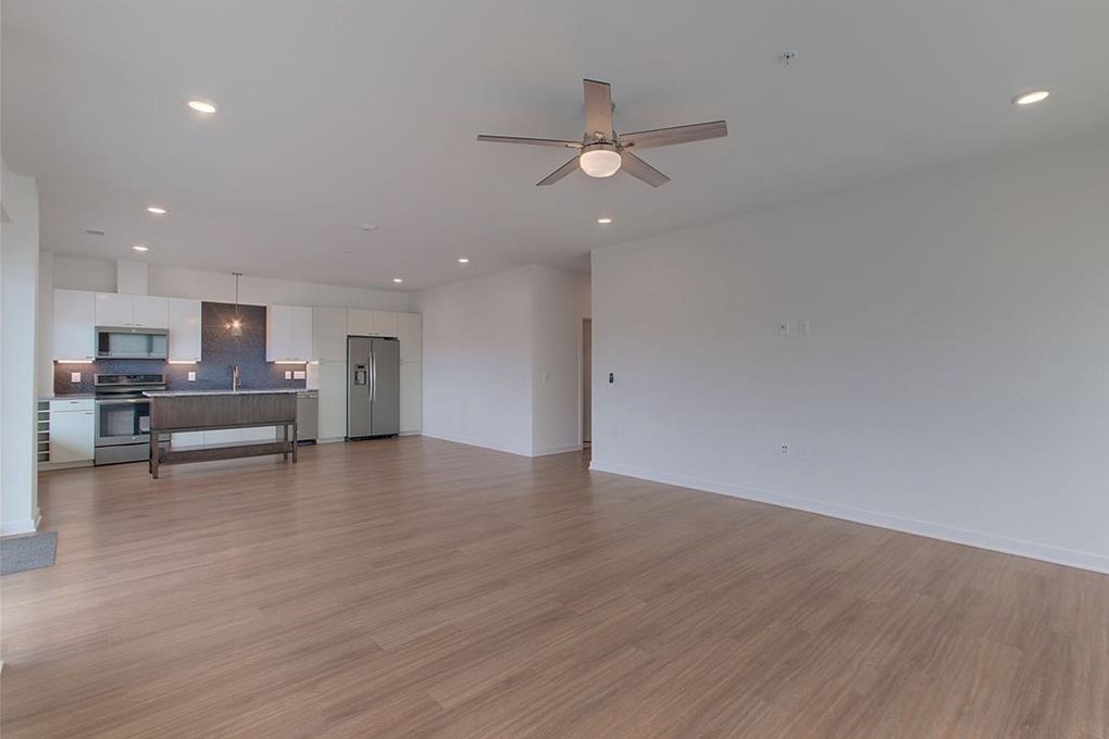 4361 South Congress Avenue, Unit 210 Austin, TX 78745 - Photo 4 of 30 a view of kitchen with wooden floor and window