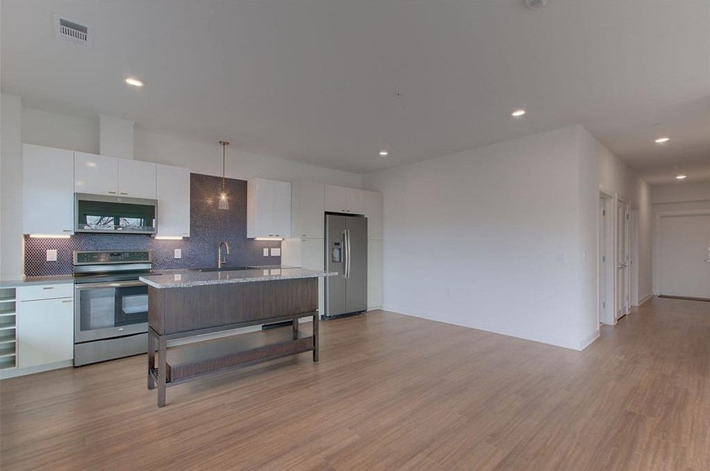 4361 South Congress Avenue, Unit 210 Austin, TX 78745 - Photo 5 of 30 a view of kitchen with cabinets and wooden floor