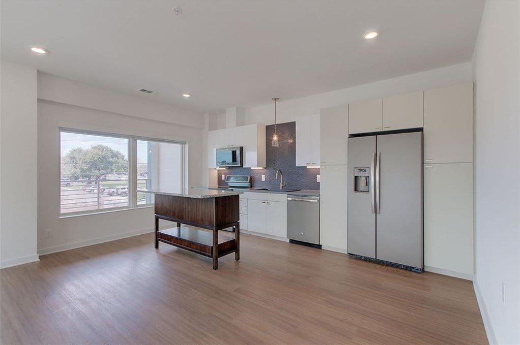 4361 South Congress Avenue, Unit 210 Austin, TX 78745 - Photo 6 of 30 a living room with furniture and a wooden floor