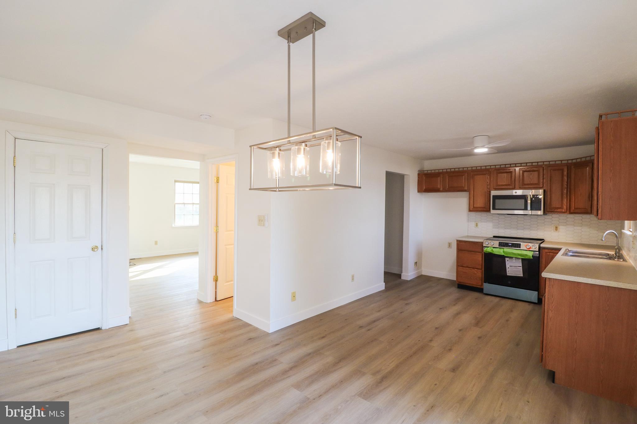 552 Locust Street Hanover, PA 17331 - Photo 4 of 32 a living room with stainless steel appliances furniture and wooden floor