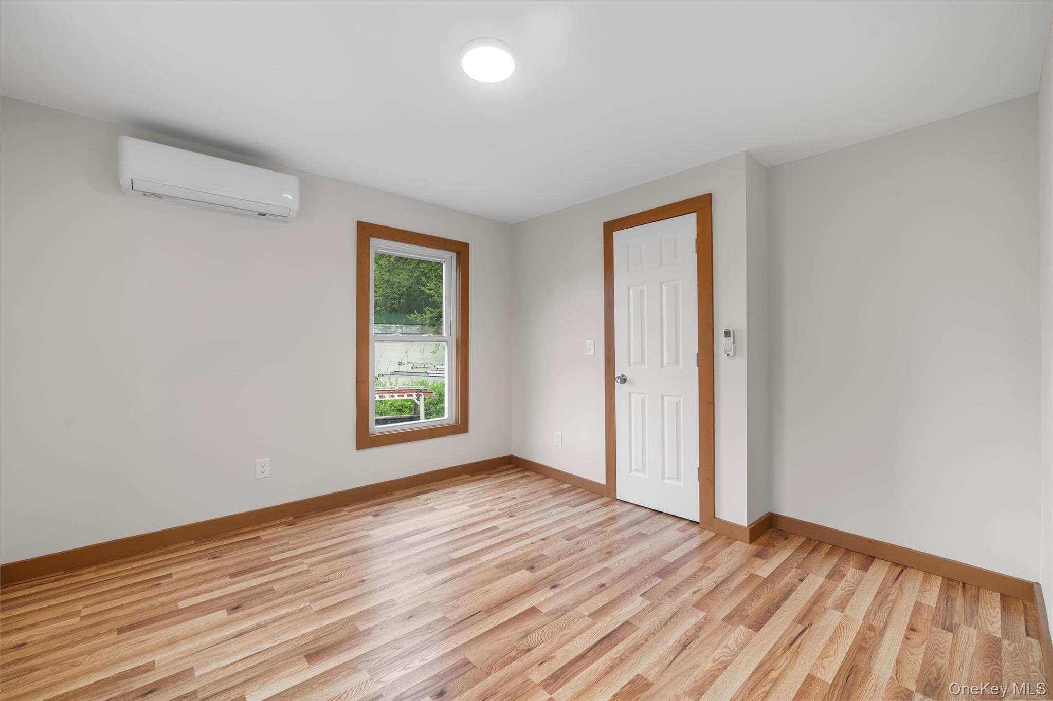 15 Riley Road New Windsor, NY 12553 - Photo 17 of 33 a view of an empty room with wooden floor and a window
