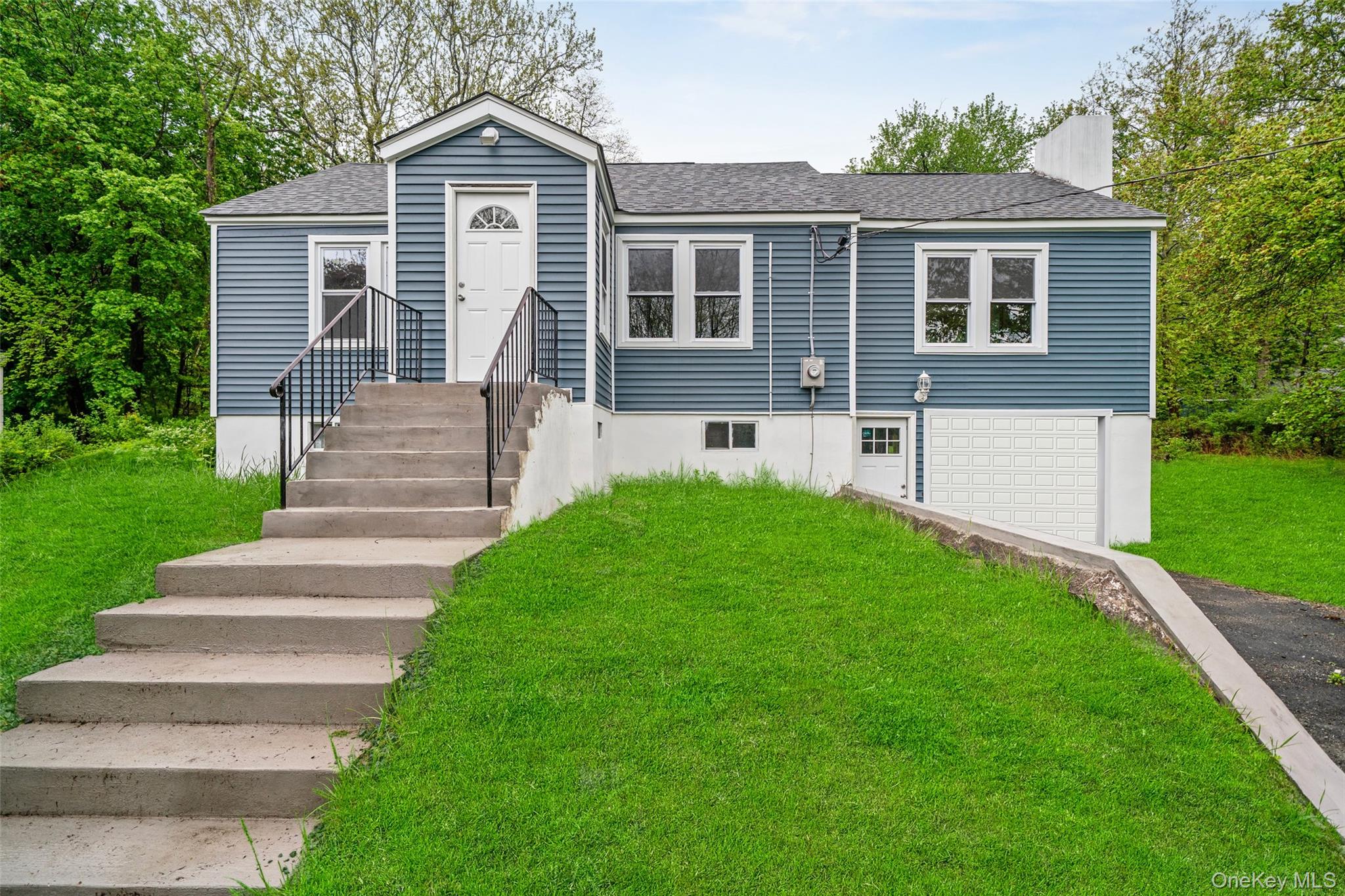 15 Riley Road New Windsor, NY 12553 - Photo 2 of 33 a front view of a house with a yard and garage