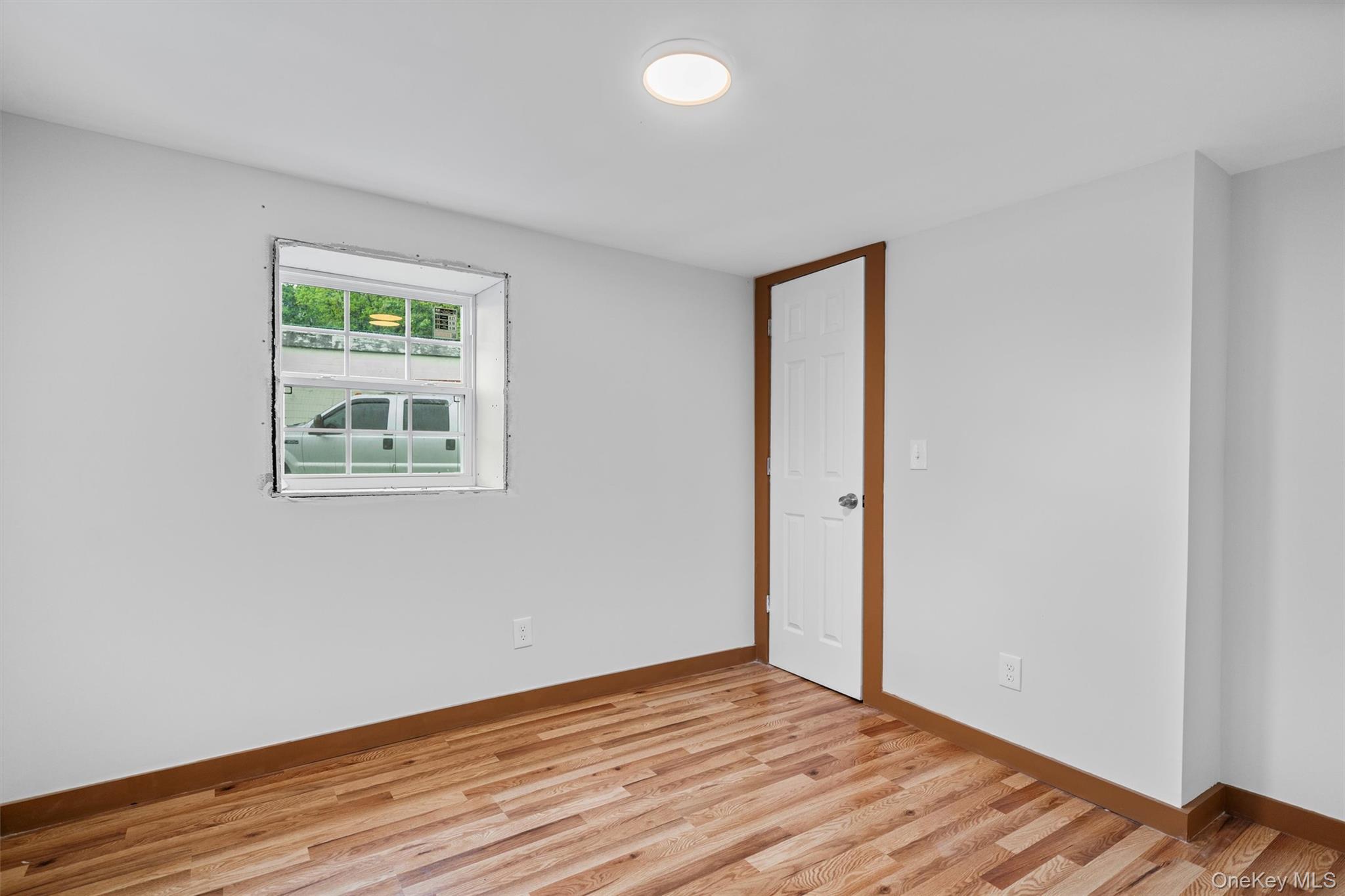 15 Riley Road New Windsor, NY 12553 - Photo 28 of 33 a view of an empty room with wooden floor and a window