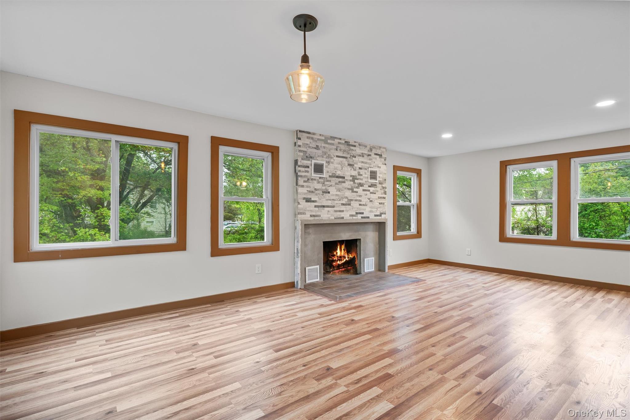 15 Riley Road New Windsor, NY 12553 - Photo 10 of 33 wooden floor fireplace and windows in an empty room
