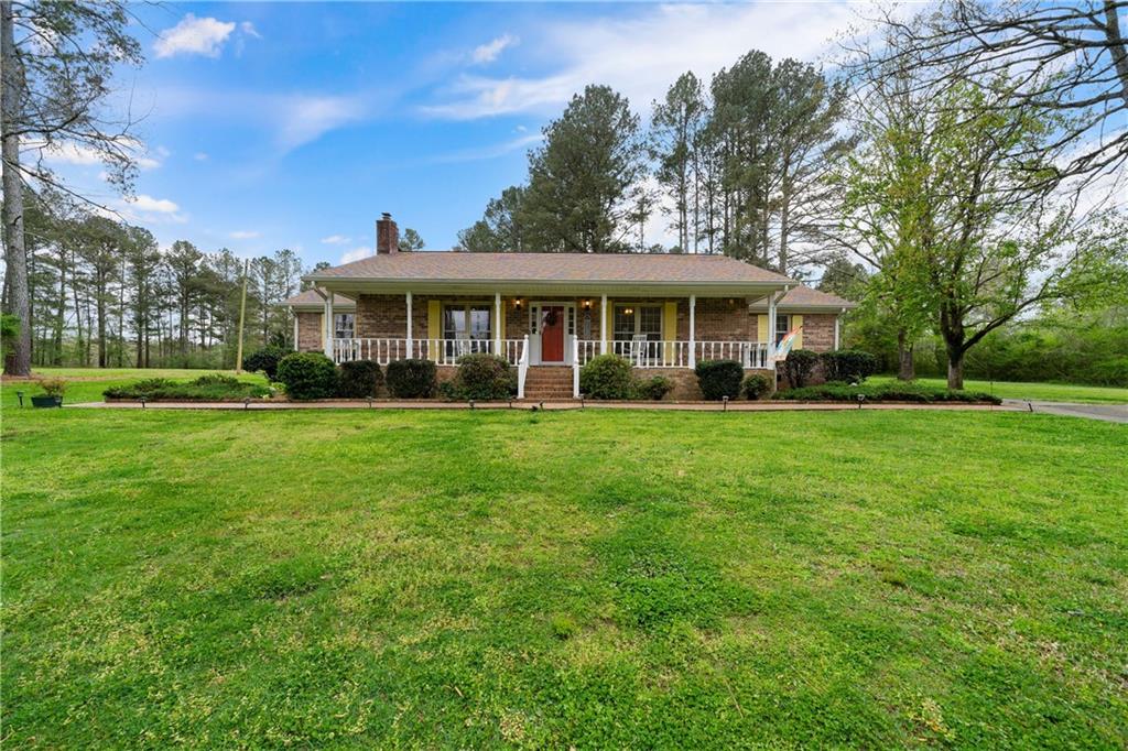 1439 Turner Road Northeast Rome, GA 30165 - Photo 1 of 1 a front view of a house with a garden
