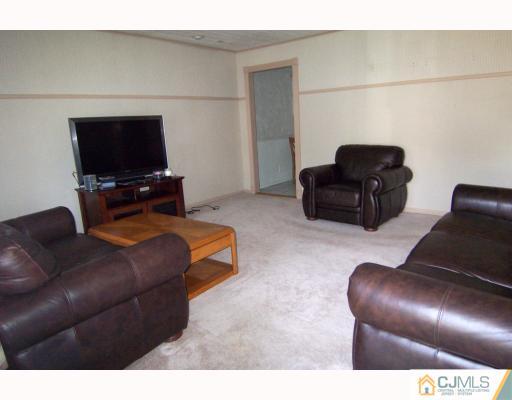 29 Brookville Road Edison, NJ 08817 - Photo 2 of 10 a living room with furniture and a flat screen tv