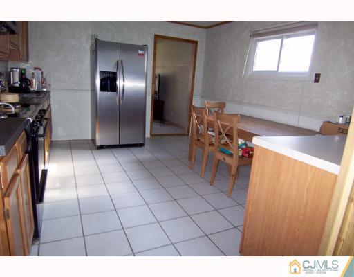 29 Brookville Road Edison, NJ 08817 - Photo 4 of 10 a kitchen with granite countertop a refrigerator and a sink