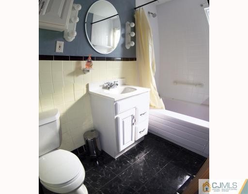 29 Brookville Road Edison, NJ 08817 - Photo 7 of 10 a bathroom with a sink a toilet and a mirror