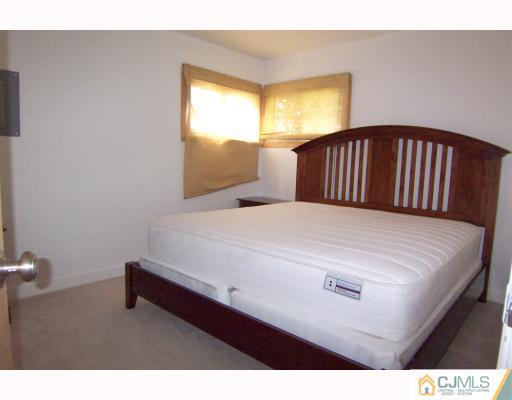 29 Brookville Road Edison, NJ 08817 - Photo 8 of 10 a bedroom with a bed and window