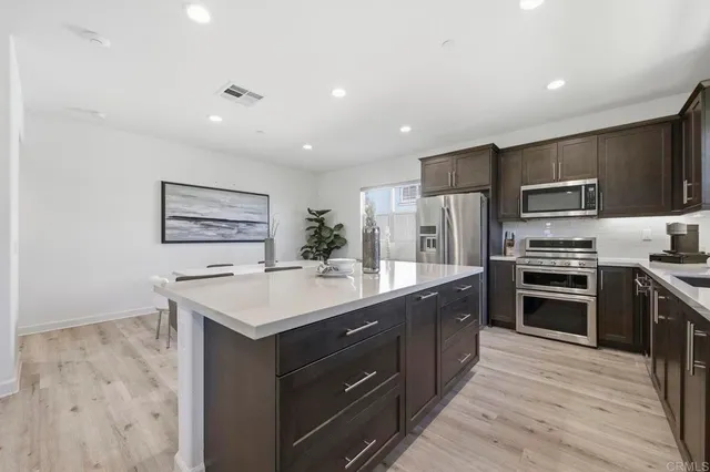 a kitchen with kitchen island appliances cabinets and counter space