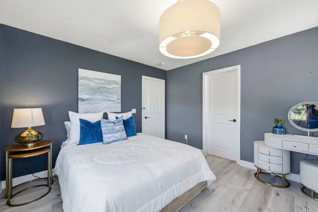 a bedroom with a bed and a potted plant