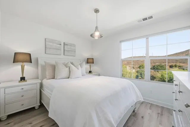 a bedroom with a large bed and a window
