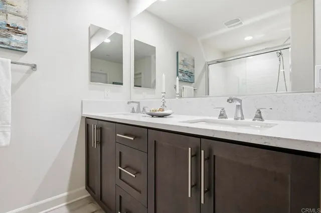 a bathroom with a double vanity sink and mirror